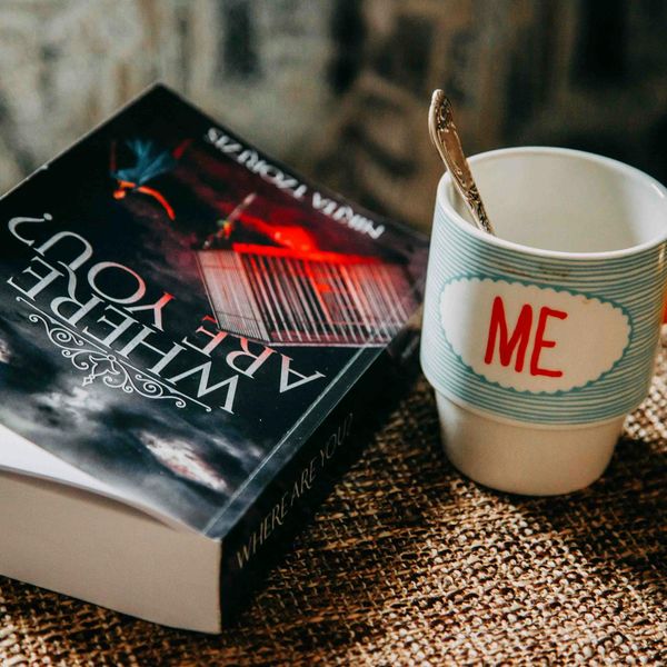 A serene scene with yoga mat, a book, and a cup of tea.